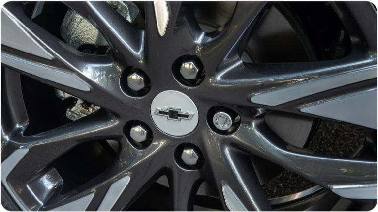 Tapa central de llanta color  plateado con emblema negro del Chevrolet Onix.