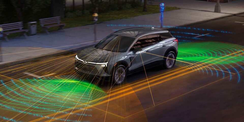 Imagen de un Chevrolet Blazer EV estacionado y varias lineas y ondas que salen de él, para dar cuenta del alcance los sensores del vehículo.